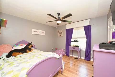 a bedroom with a bed and a chandelier