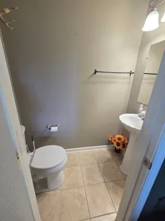 a bathroom with a toilet a sink and a mirror