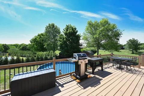 a view of a deck with furniture and a yard