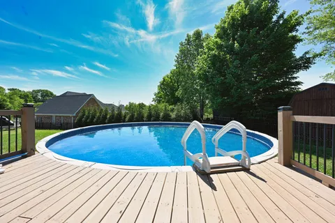 a view of roof deck with a barbeque grill and wooden fence