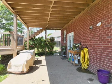 a view of a patio with table and chairs potted plants