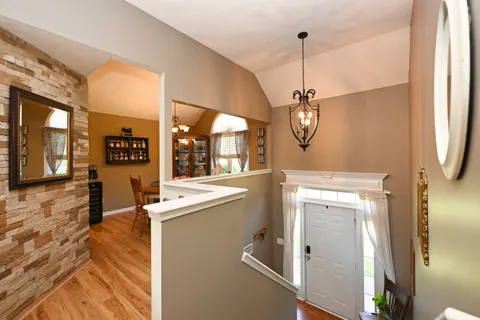 a view of a kitchen with a sink and dishwasher a refrigerator with wooden floor