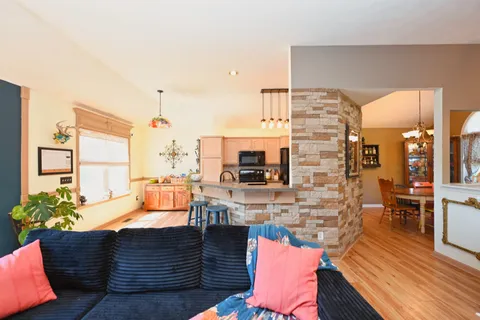 a living room with fireplace furniture and a flat screen tv