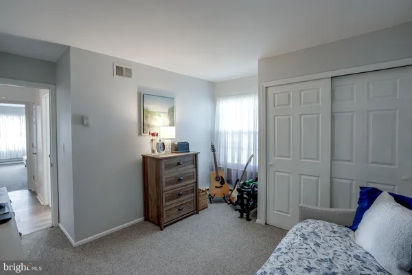 a bedroom with a bed and a dresser