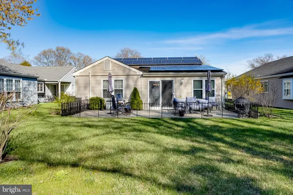 a view of a house with a backyard porch and sitting area