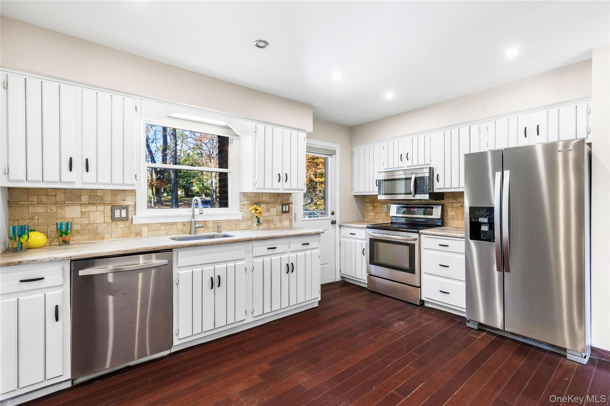 610 Granite Springs Road Yorktown Heights, NY 10598 - Photo 11 of 34 a kitchen with white cabinets stainless steel appliances a sink and a window