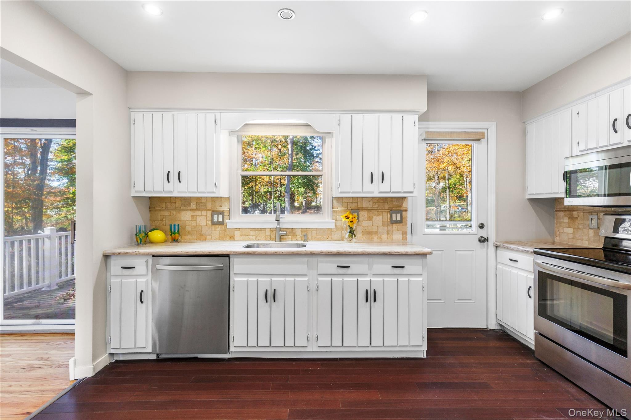610 Granite Springs Road Yorktown Heights, NY 10598 - Photo 12 of 34 a kitchen with stainless steel appliances granite countertop a stove a sink wooden cabinets and wooden floors