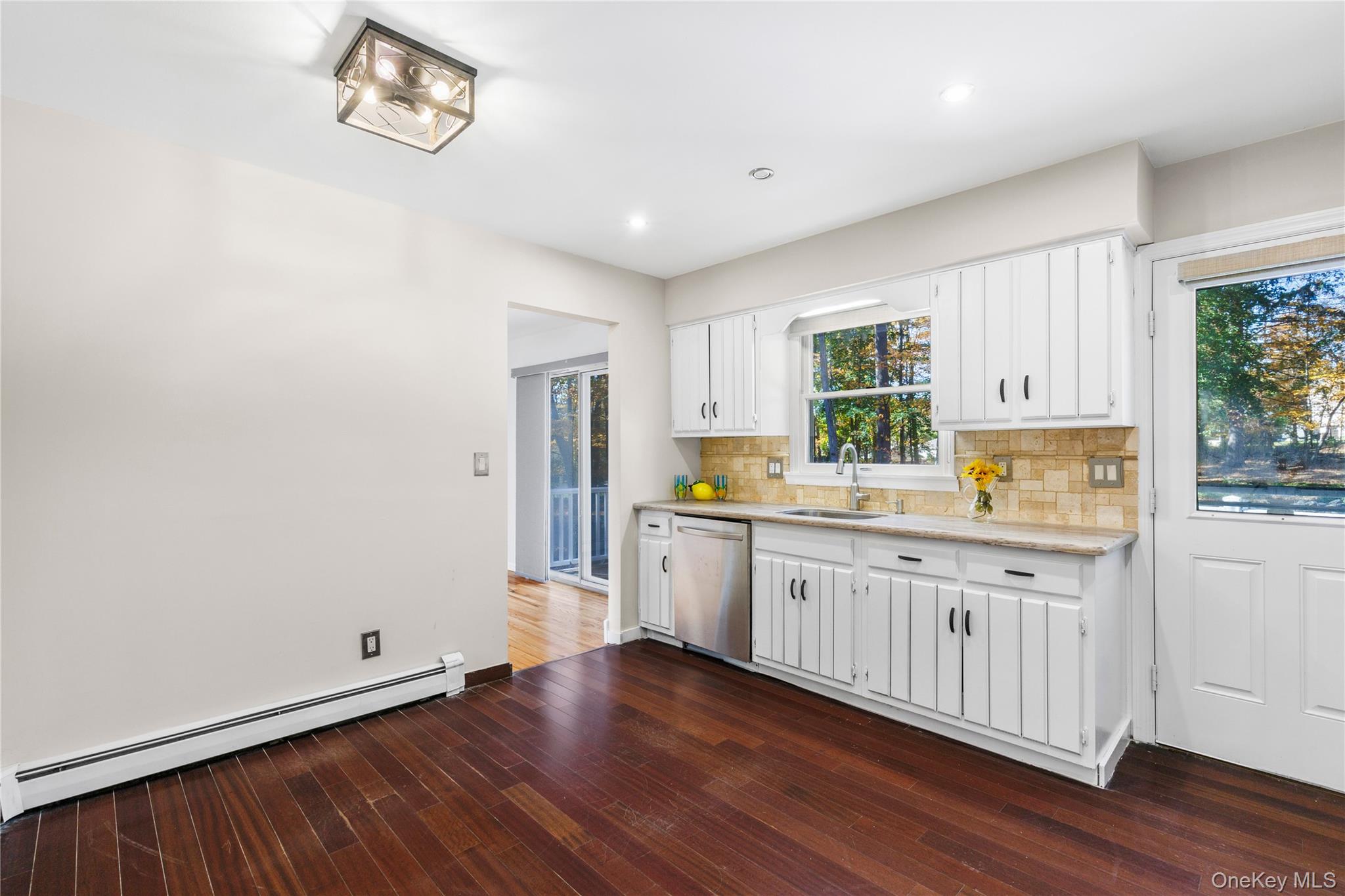 610 Granite Springs Road Yorktown Heights, NY 10598 - Photo 14 of 34 a kitchen with granite countertop white cabinets and wooden floor