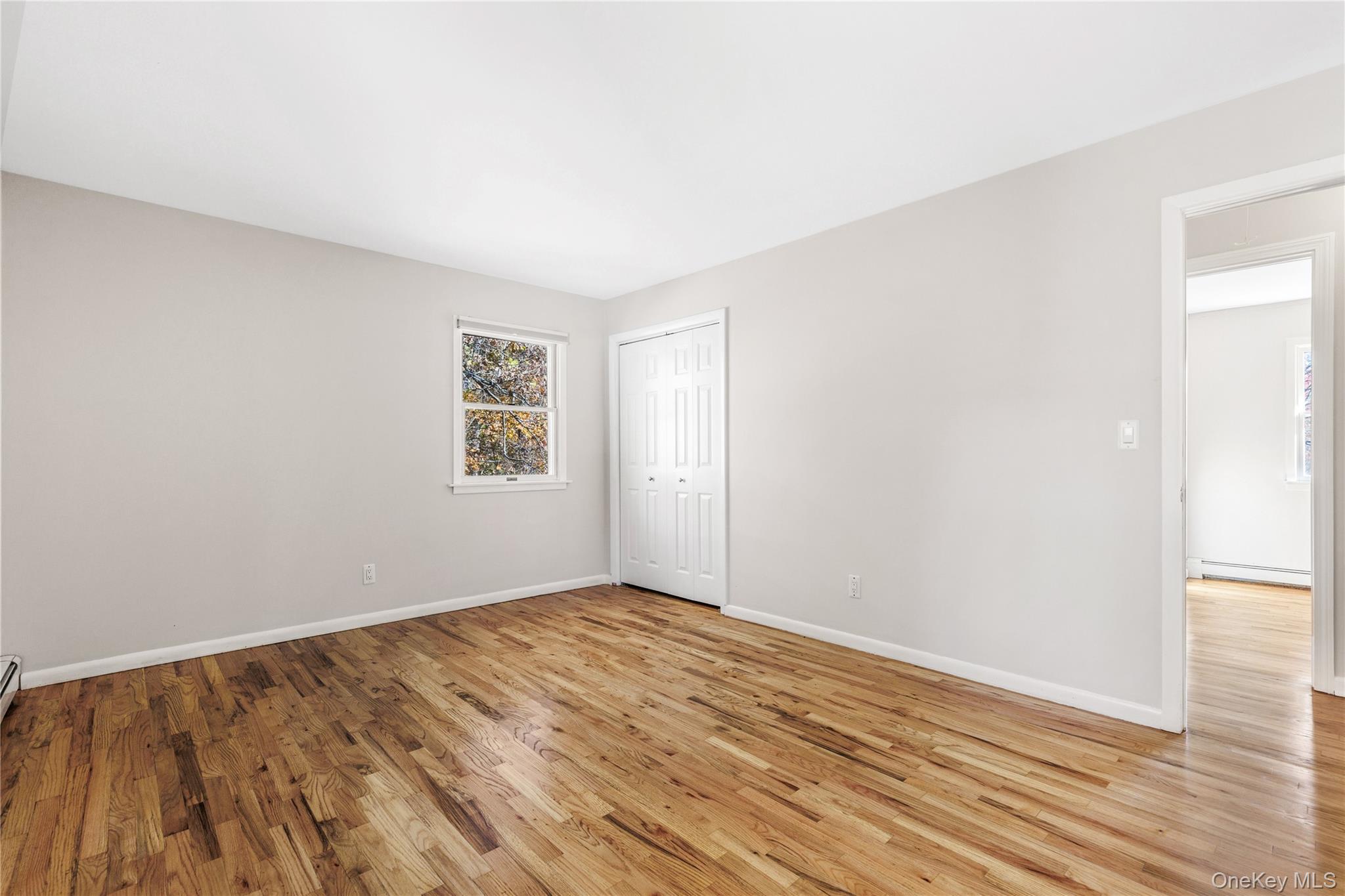 610 Granite Springs Road Yorktown Heights, NY 10598 - Photo 16 of 34 an empty room with wooden floor and windows