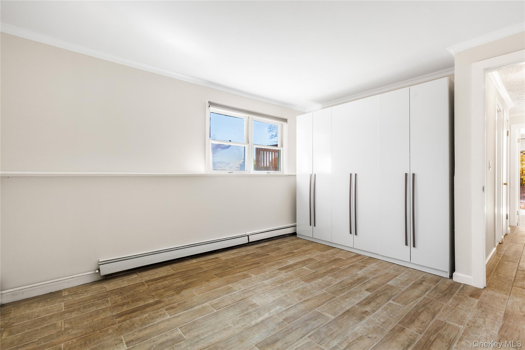 610 Granite Springs Road Yorktown Heights, NY 10598 - Photo 22 of 34 an empty room with wooden floor and windows