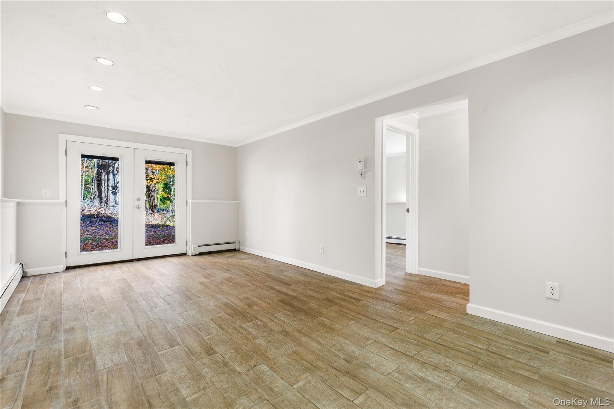 610 Granite Springs Road Yorktown Heights, NY 10598 - Photo 24 of 34 an empty room with wooden floor and windows