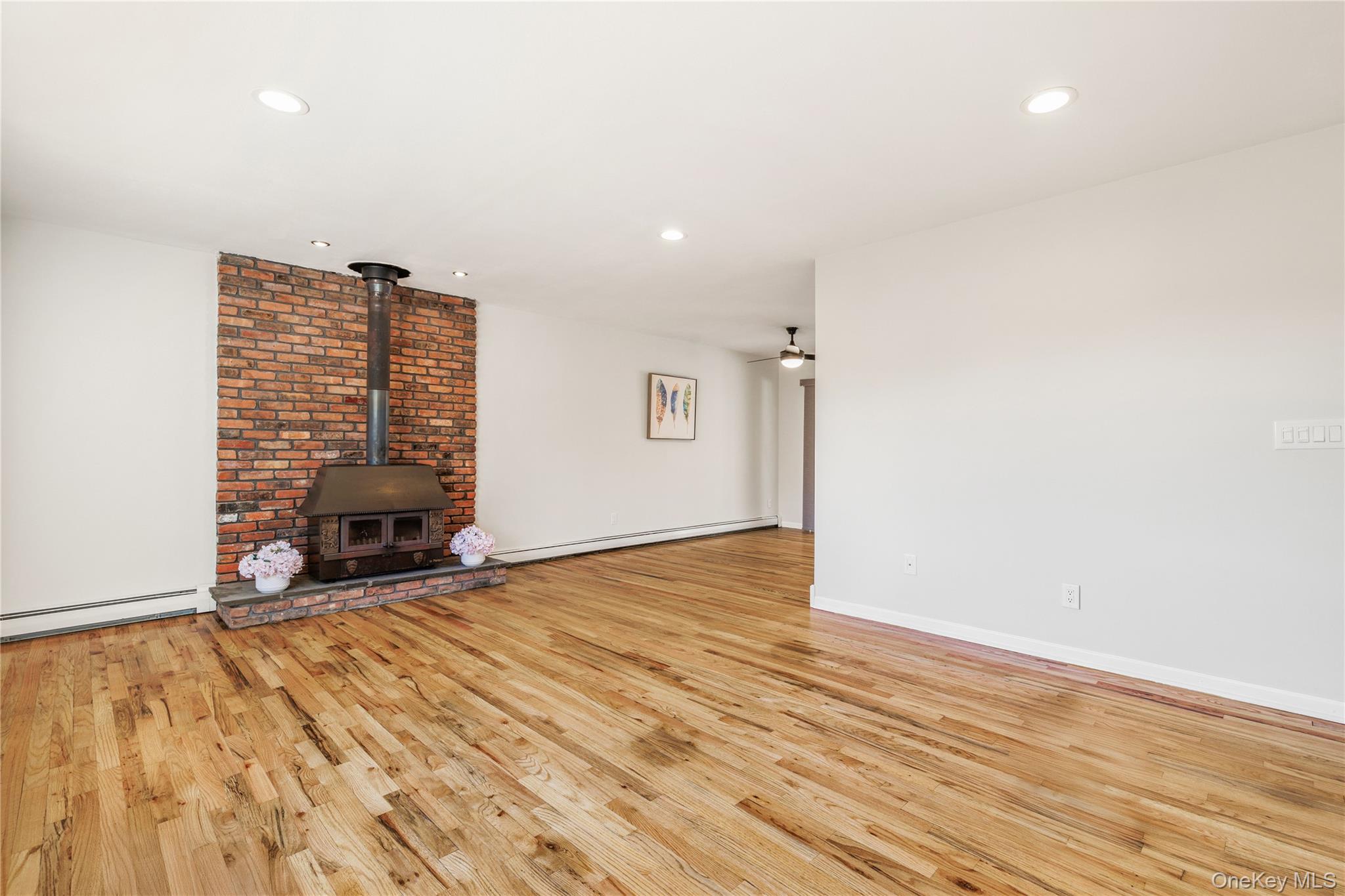 610 Granite Springs Road Yorktown Heights, NY 10598 - Photo 4 of 34 a view of an empty room with wooden floor and a fireplace