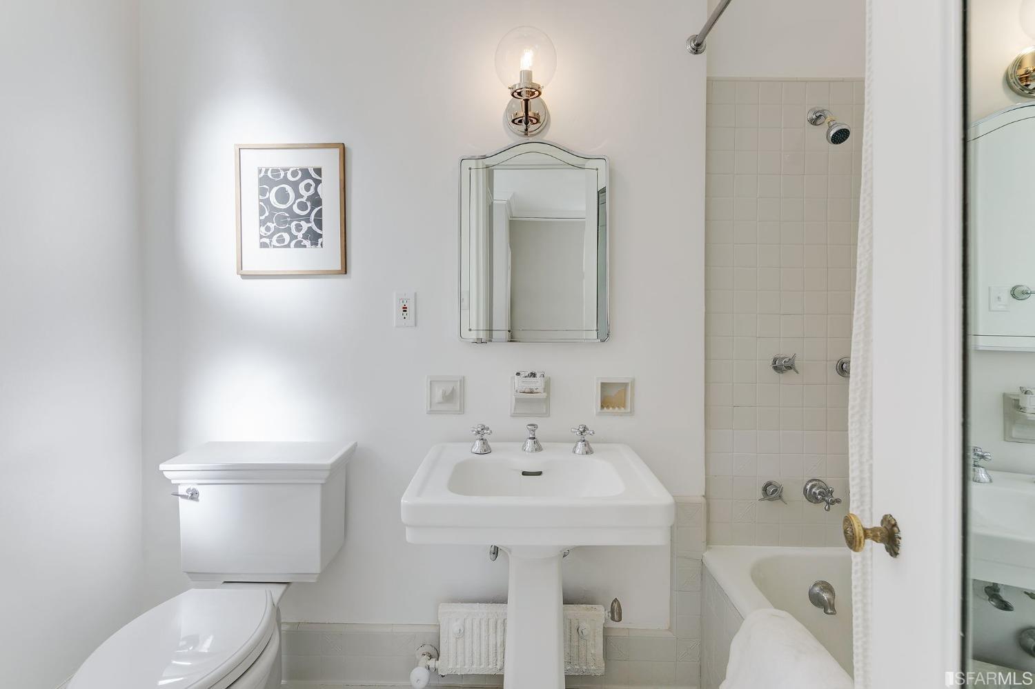 3212 Jackson Street San Francisco, CA 94118 - Photo 16 of 33 a bathroom with a toilet a sink and mirror