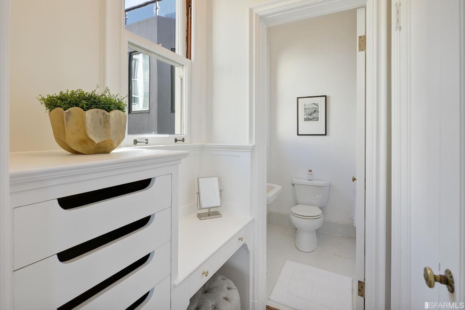 3212 Jackson Street San Francisco, CA 94118 - Photo 19 of 33 a bathroom with a toilet a sink and mirror