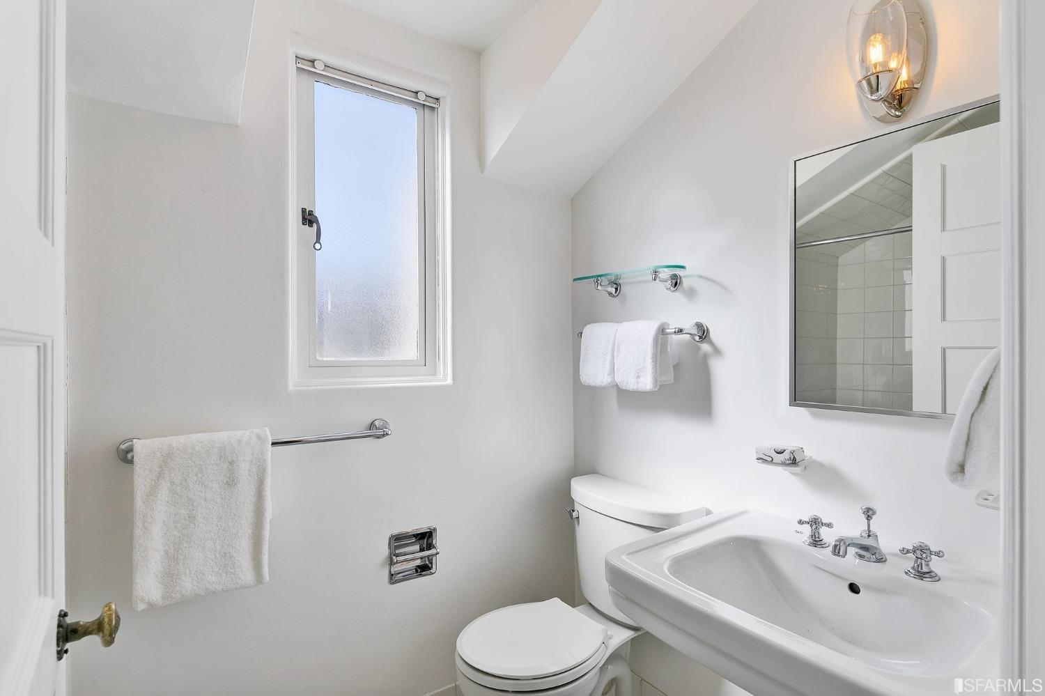 3212 Jackson Street San Francisco, CA 94118 - Photo 25 of 33 a bathroom with a toilet sink and mirror