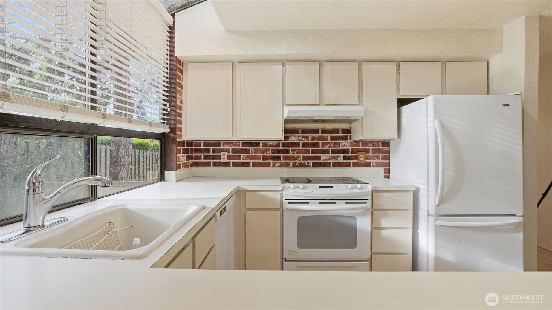 1850 Grant Avenue South, Unit D5 Renton, WA 98055 - Photo 13 of 25 a kitchen with a sink a stove and refrigerator