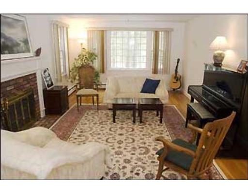 20 Axdell Road Sudbury, MA 01776 - Photo 7 of 17 a living room with furniture a large window and a fireplace