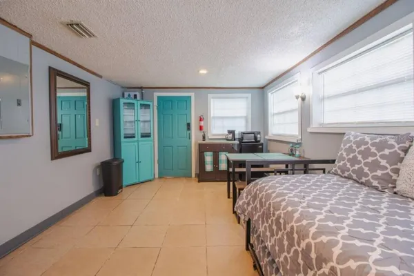 a bedroom with a bed and window