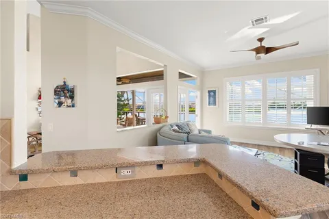 a large white kitchen with a large window