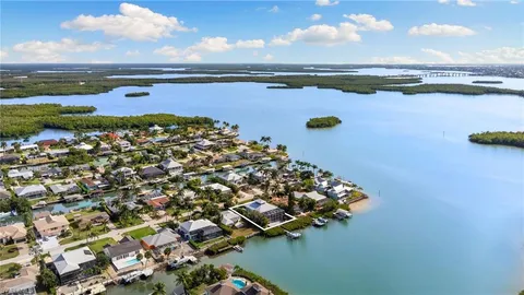 an aerial view of a houses with ocean view