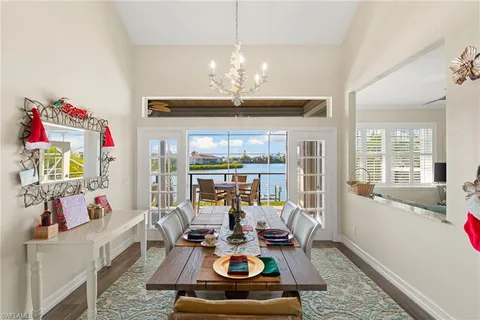 a view of a dining room with furniture a chandelier and a rug