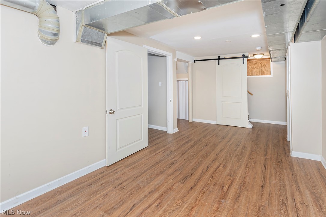 917 Brunswick Road Cleveland Heights, OH 44112 - Photo 36 of 42 Fresh finished, waterproofed basement with vinyl plank flooring and overhead light, complete with half bath and additional storage.