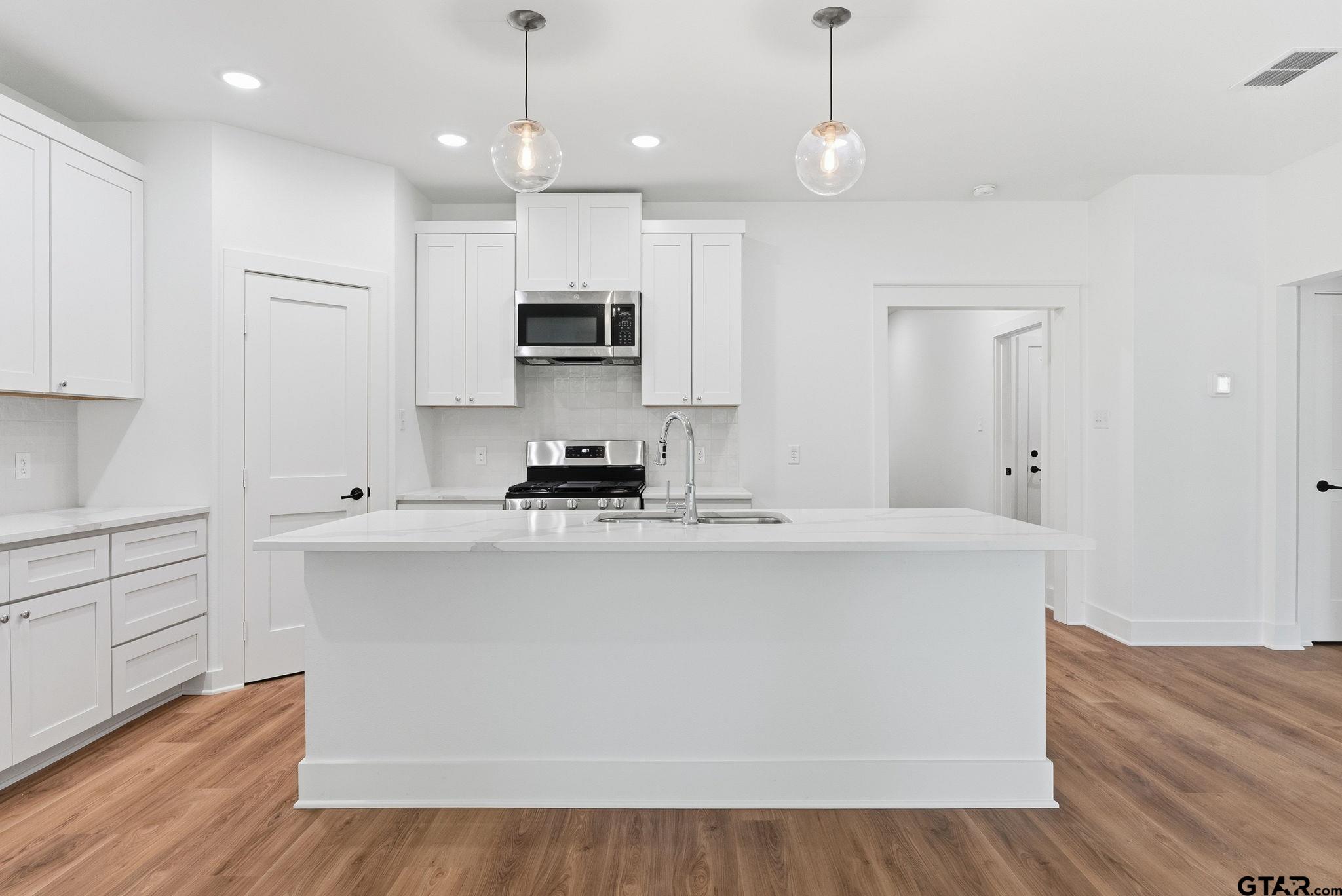 2968 Calloway Road Tyler, TX 75701 - Photo 7 of 24 a kitchen with stainless steel appliances a stove top oven a sink and a refrigerator