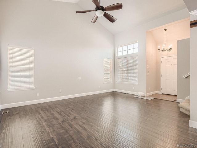 an empty room with wooden floor and a window