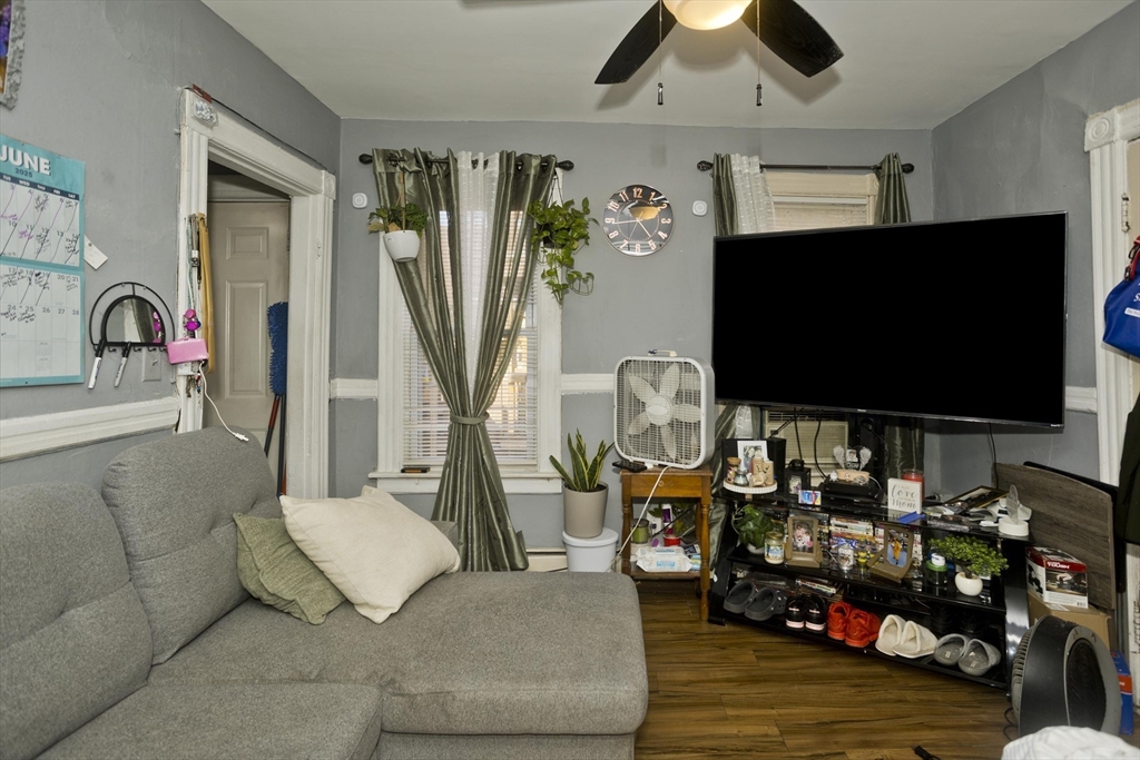 89-95 School Street Chicopee, MA 01013 - Photo 17 of 39 a living room with furniture and a flat screen tv