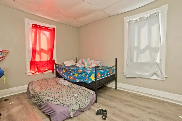 a bedroom with a bed and window