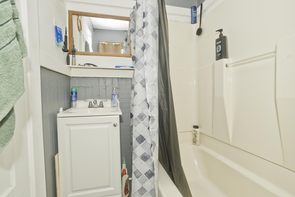 89-95 School Street Chicopee, MA 01013 - Photo 23 of 39 a bathroom with a sink a toilet and shower