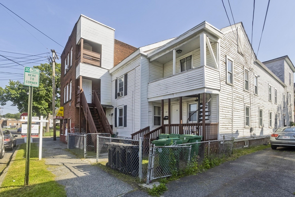 89-95 School Street Chicopee, MA 01013 - Photo 32 of 39 a front view of a house with a yard