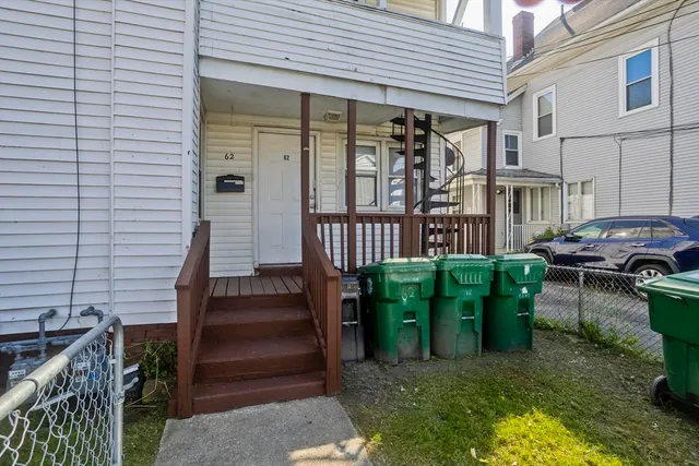 a view of a patio with table and chairs with wooden fence