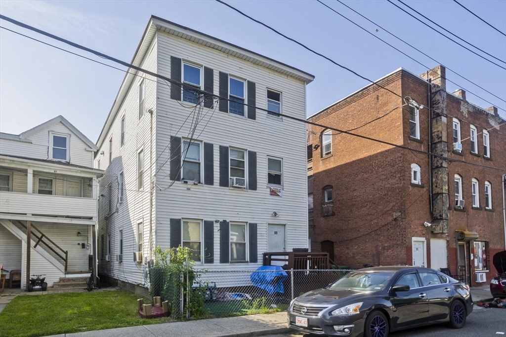 89-95 School Street Chicopee, MA 01013 - Photo 34 of 39 a front view of a building with cars parked