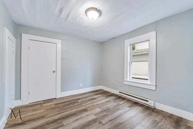 an empty room with a empty space and windows