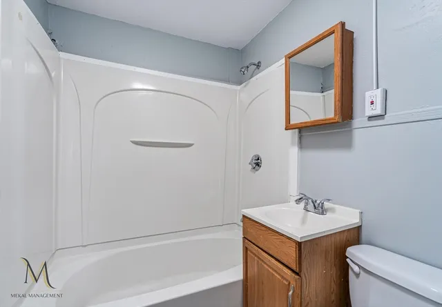a bathroom with a sink toilet and vanity