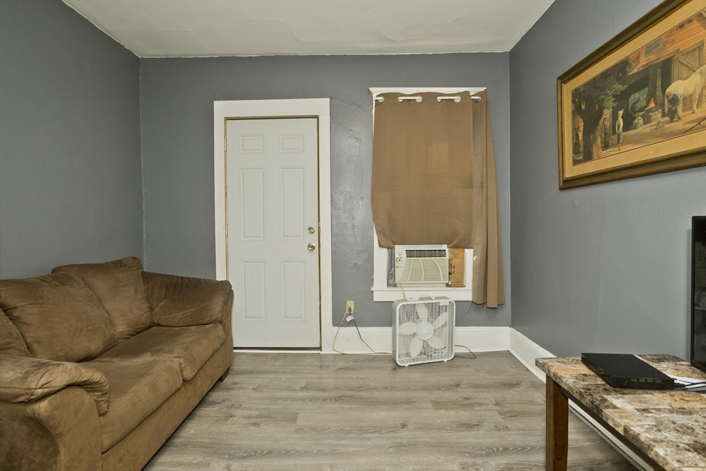 89-95 School Street Chicopee, MA 01013 - Photo 8 of 39 a living room with furniture and wooden floor