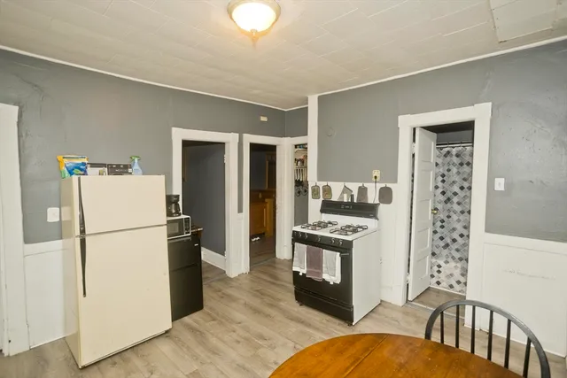 a kitchen with a refrigerator a stove top oven and a refrigerator