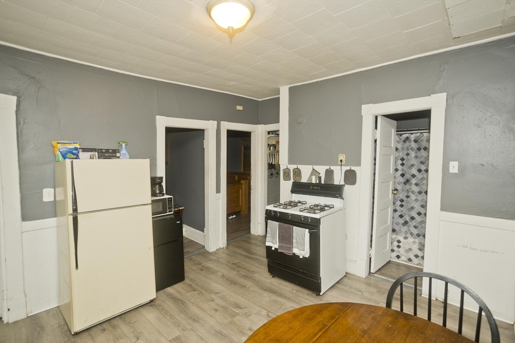 89-95 School Street Chicopee, MA 01013 - Photo 10 of 39 a kitchen with a refrigerator a stove top oven and a refrigerator