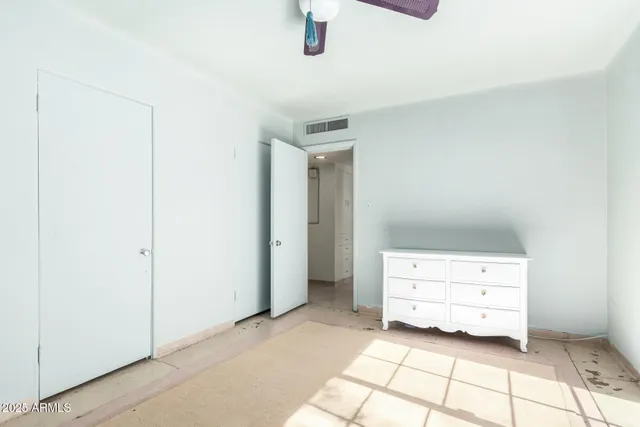 a view of room with baby crib and dresser