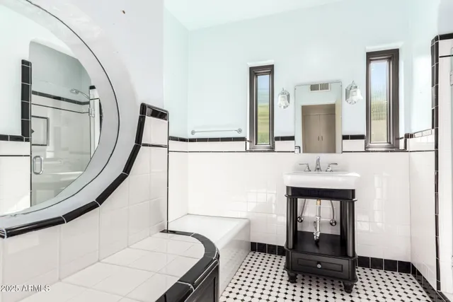 a bathroom with a sink a toilet and mirror