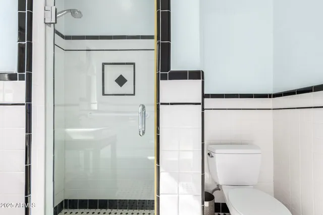 a bathroom with a toilet and a shower