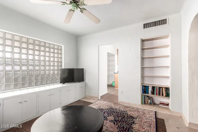 a living room with a flat screen tv and a rug