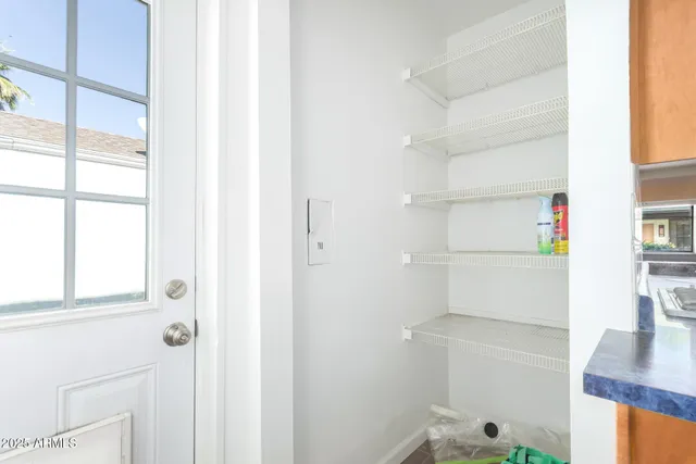 a view of storage and utility room with racks on the wall