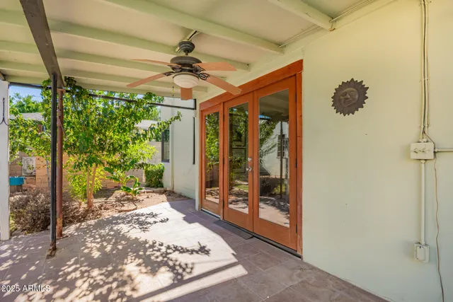 a view of a porch with a table and chairs