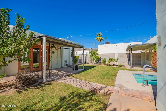 a view of a house with backyard porch and sitting area