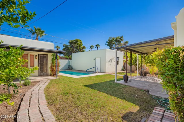 a view of a house with backyard and a patio