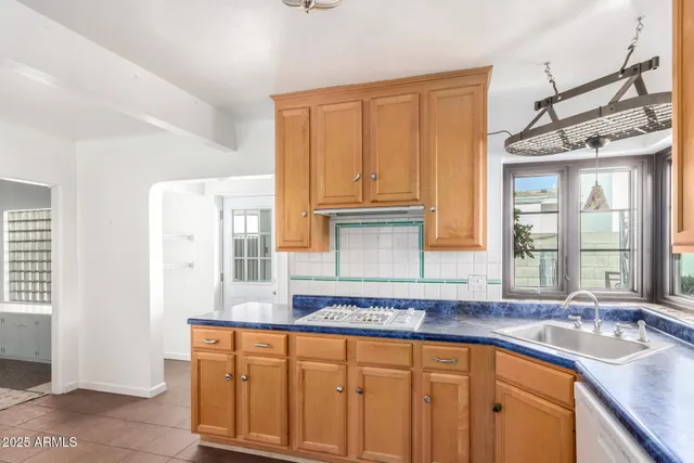 a kitchen with stainless steel appliances granite countertop a sink and dishwasher next to a window