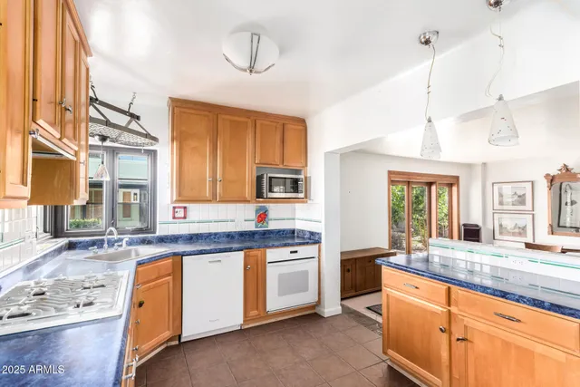 a kitchen with stainless steel appliances granite countertop a stove and a sink