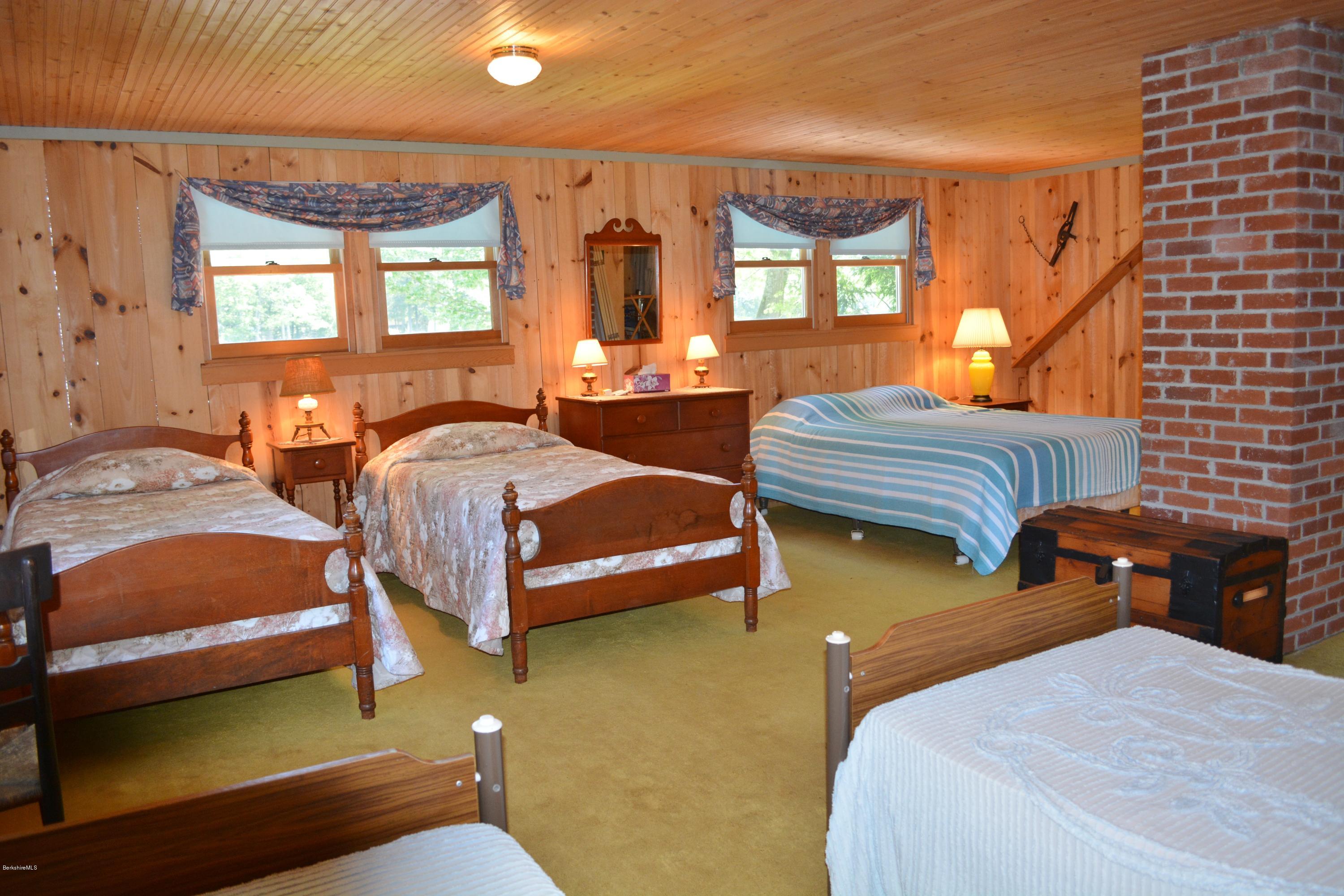 87 North Gate Island Road Otis, MA 01029 - Photo 11 of 15 a bedroom with two beds and a dresser next to a window